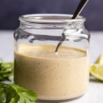 Chipotle Ranch Dressing in a clear glass jar with a spoon