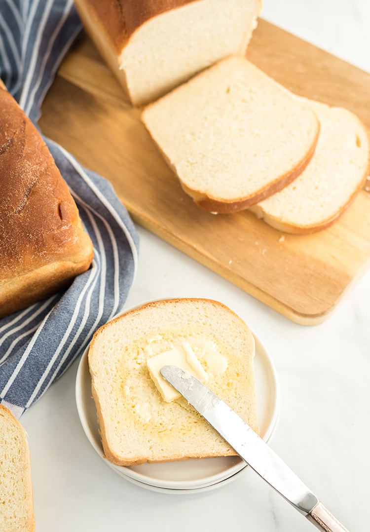 Homemade white bread on a plate with butter