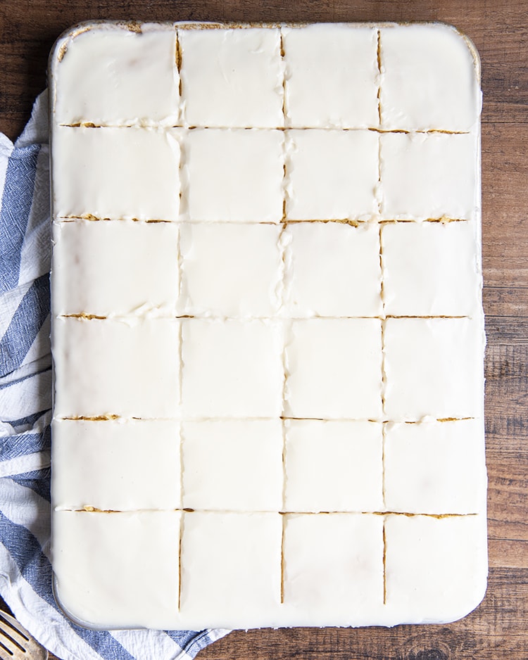A white sheet cake sliced into twenty four slices