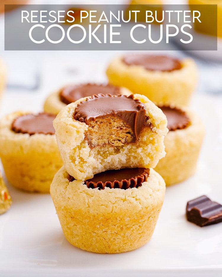 Peanut Butter Cup Cookie Cups with a sugar cookie with a reeses cup in the middle with a bite taken out of it.