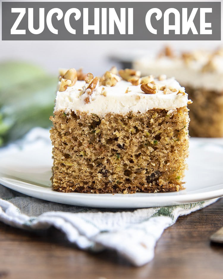A slice of zucchini cake with cream cheese frosting on a plate with text overlay for pinterest.