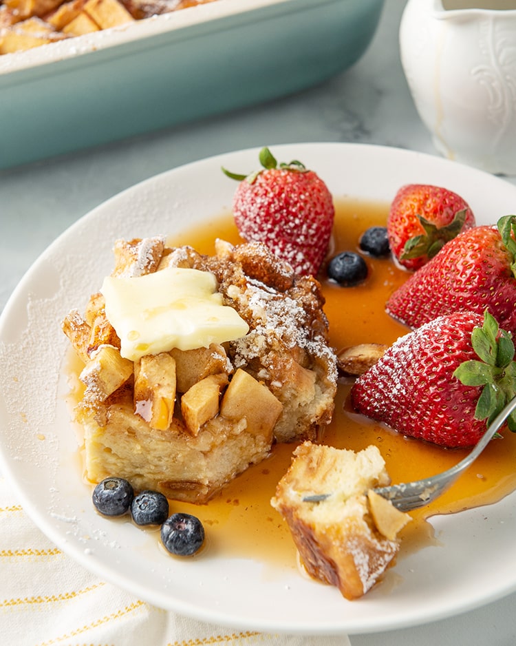 Overnight apple french toast casserole on a plate with syrup