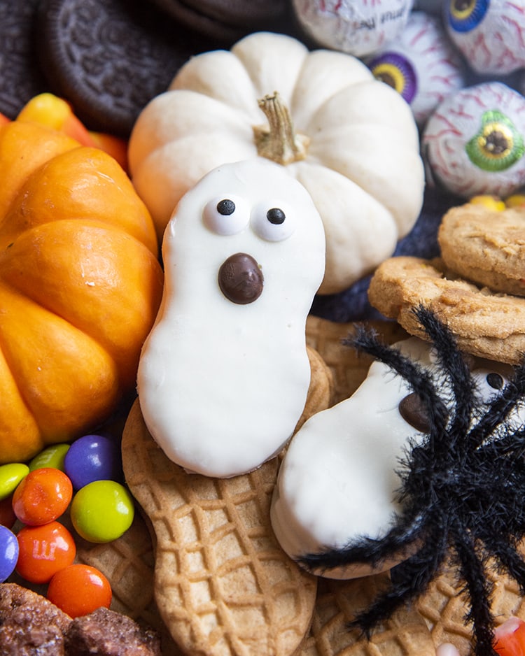 A nutter butter cookie decorated to look like a ghost.