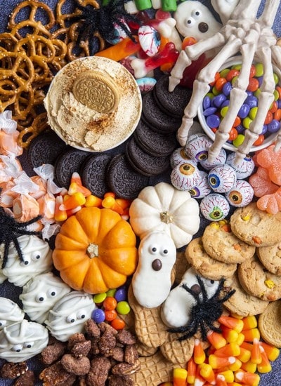 A close up or cookies, and Halloween treats piled together.