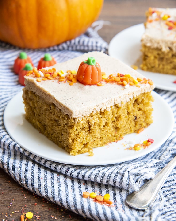 A pumpkin barA pumpkin bar is topped with cinnamon frosting, orange and yellow sprinkles, and a candy pumpkin in the middle.