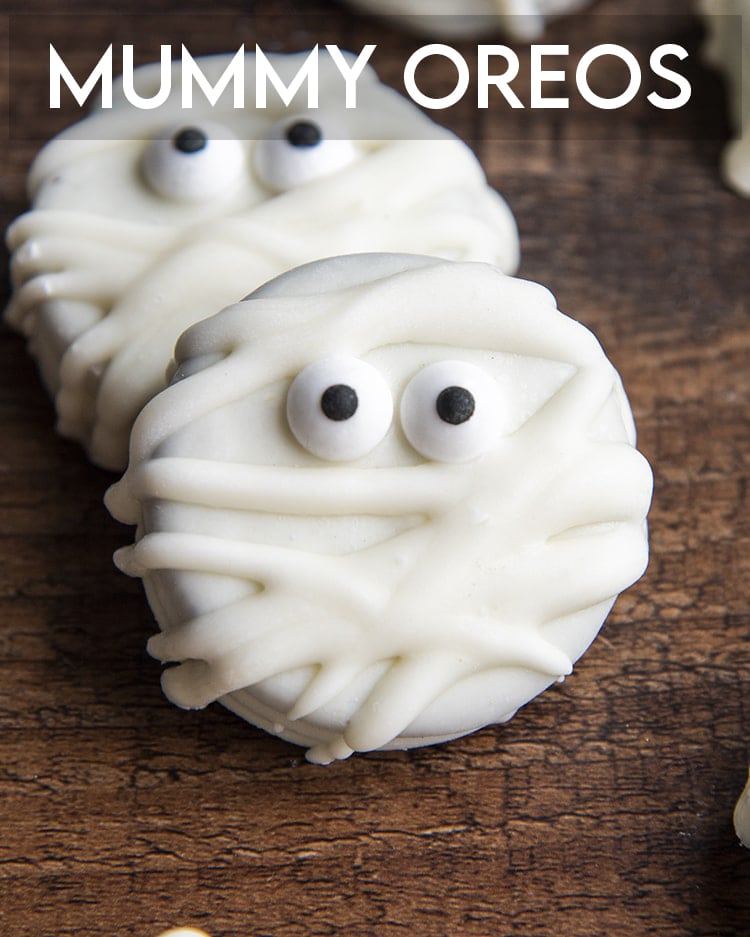 Mummy oreos dipped in white chocolate with candy eyes and text overlay that reads mummy oreos.