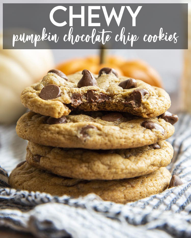 A stack of chewy pumpkin chocolate chip cookies. The top cookie has a bite taken out of it. There is a text overlay for pinterest.