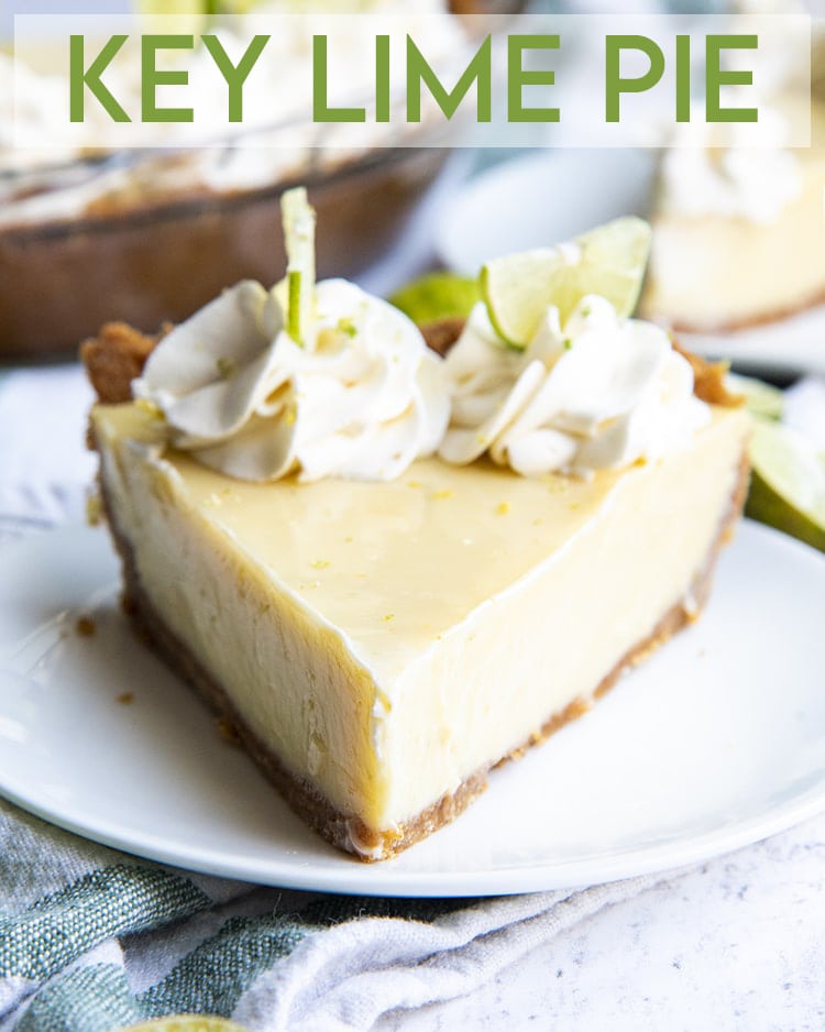 A slice of key lime pie on a white plate, topped with whipped cream dollops and thin half slices of key limes with a text overlay for pinterest.