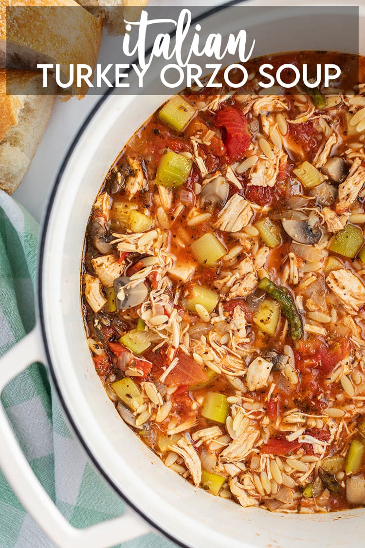 A pot of Italian Turkey Orzo Soup loaded with lots of vegetables with a text overlay saying Italian Turkey Orzo Soup.