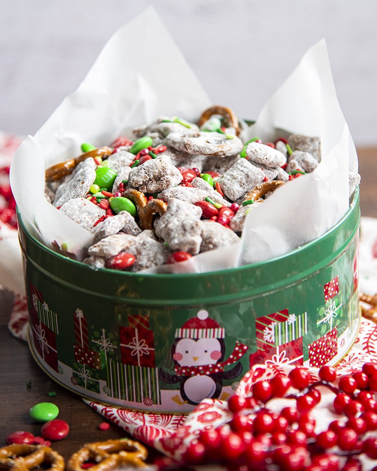 A green tin full of Christmas Reindeer Chow Muddy Buddies.