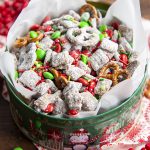 A tin full of Christmas muddy buddies, with red and green m&ms.