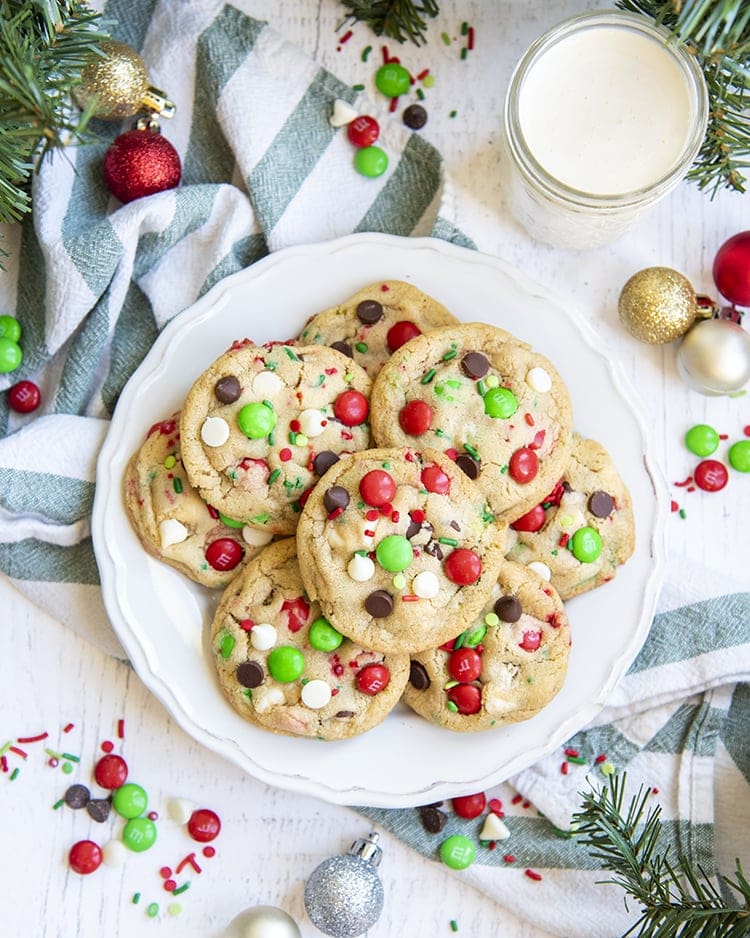 A plate of Christmassy chocolate chip cookies with red and green m&ms, perfect for Santa.