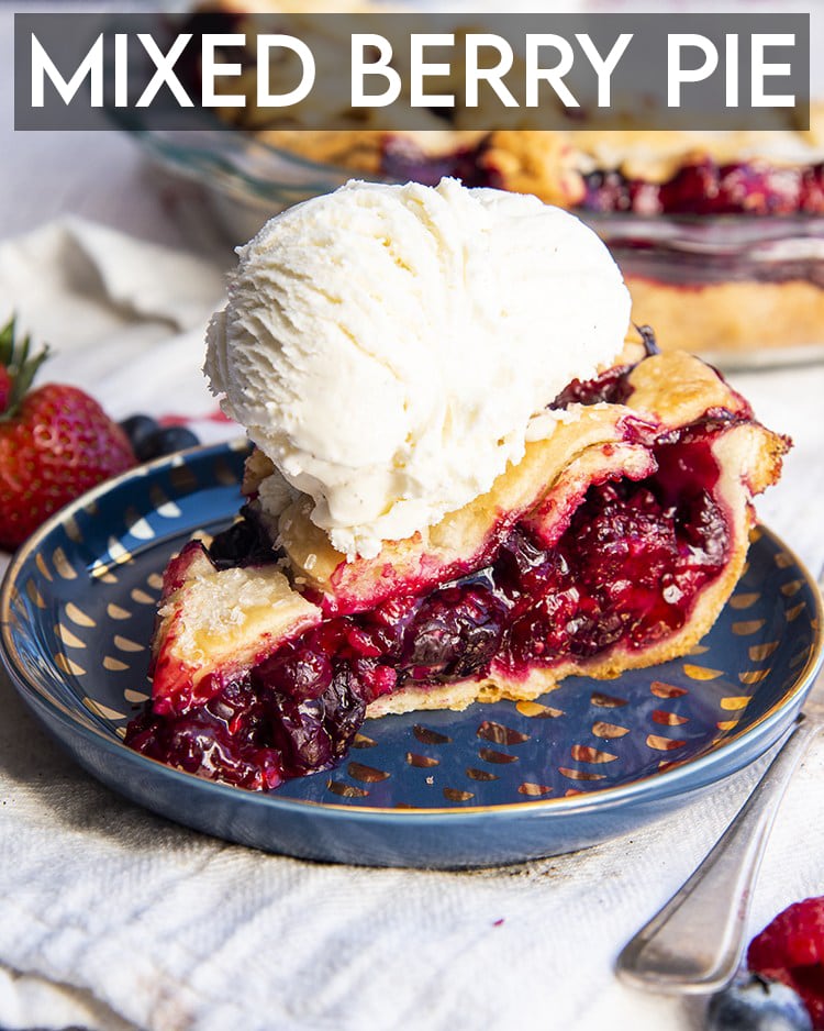 A slice of mixed berry pie on a blue plate with a scoop of vanilla ice cream on top with text.
