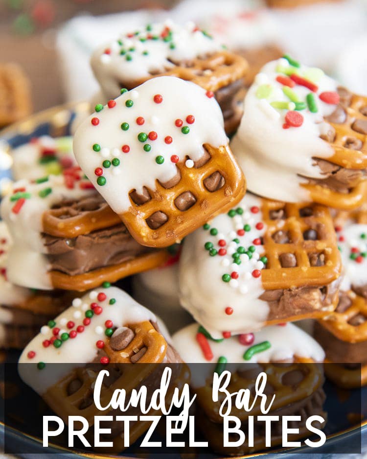 A close up of a plateful of candy bar pretzel bites, with a text overlay at the bottom for pinterst.