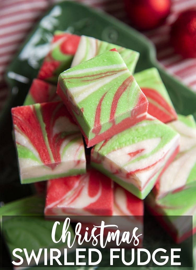 A pile of white chocolate microwave fudge, that is swirled with red and green colors throughout with a text overlay at the bottom for pinterest.