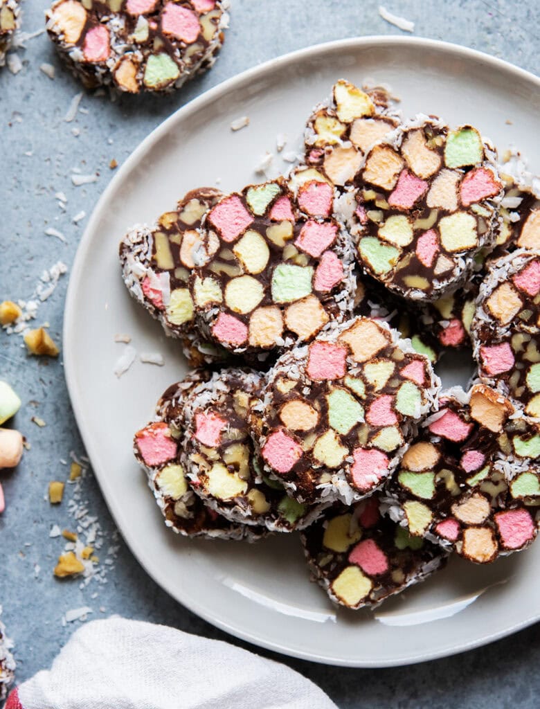 Chocolate church window cookie full of mini rainbow marshmallows on a plate.