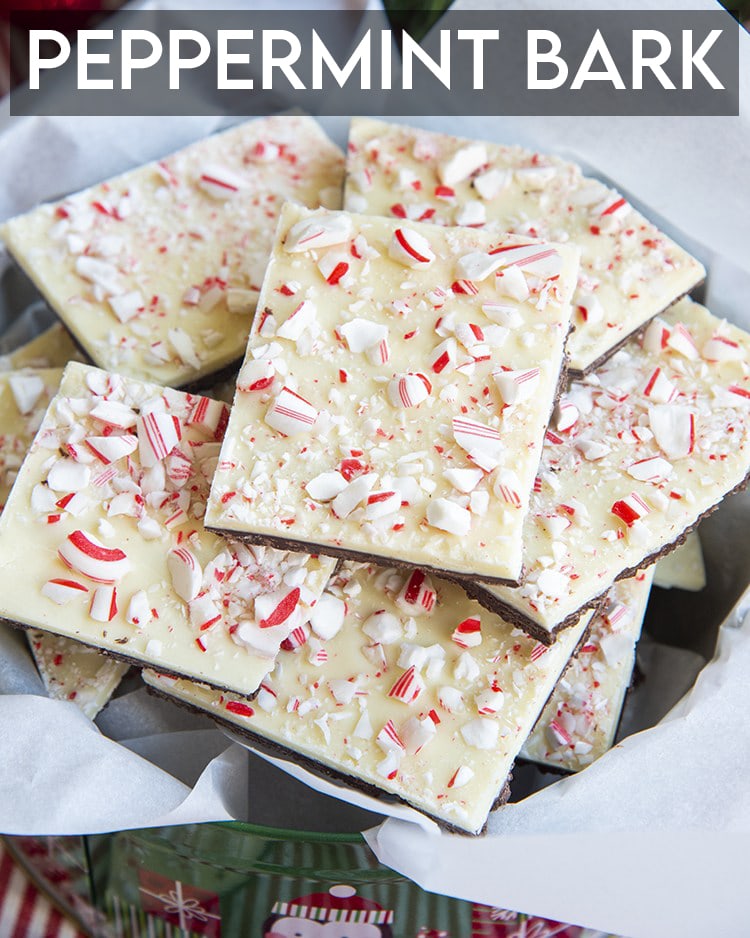 A pile of peppermint bark in a tin, with a text overlay over the top that says Peppermint Bark.
