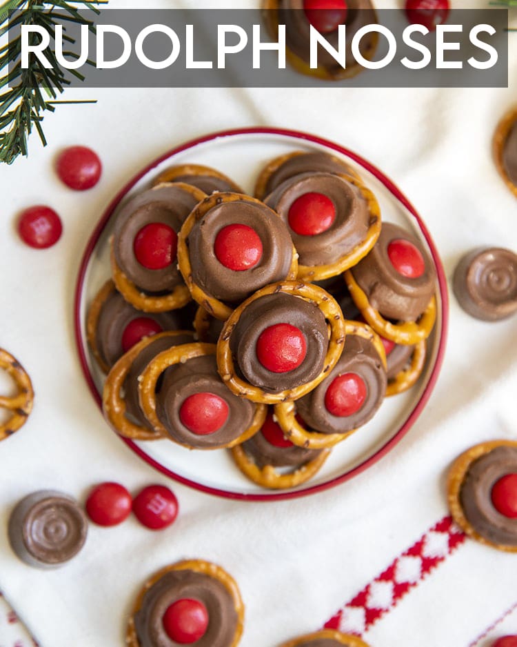 A plate of rolo candies on pretzels with m&ms on top.