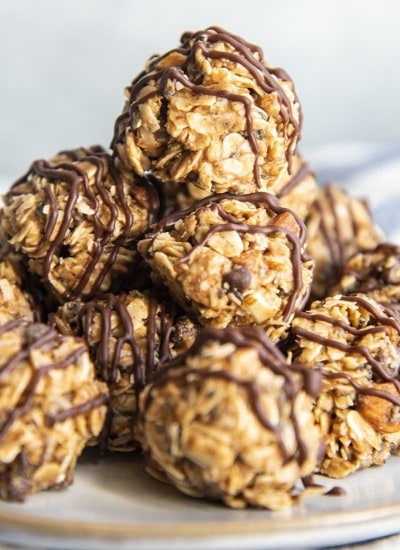 A close up shot of almond joy energy balls drizzled in chocolate.