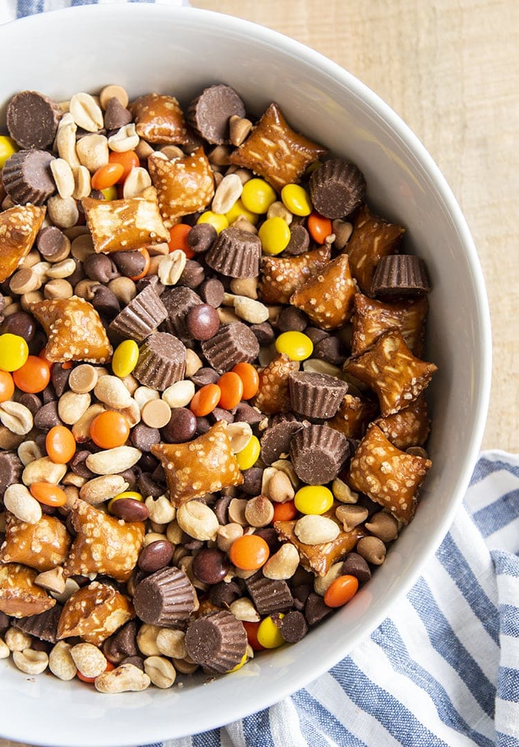 An overhead photo of a white bowl full of Chocolate Peanut Butter snack mix.