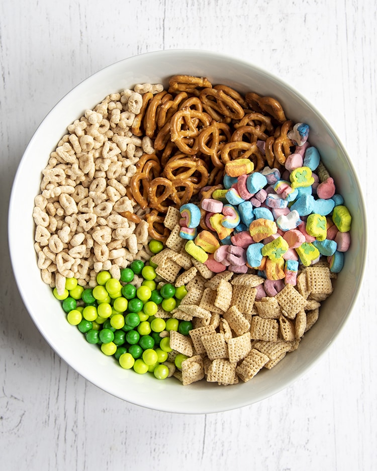 A bowl of ingredients needed to make a lucky charms snack mix.