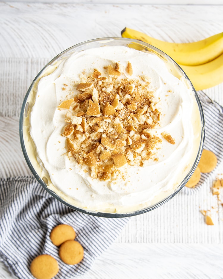 An overhead shot of banana pudding trifle, showing the whipped cream layer, and crumbled Nilla Wafer cookies on top.