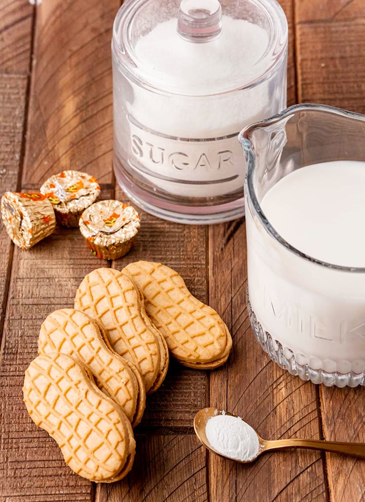A photo of sugar, milk, peanut butter cups, nutter butter cookies, and baking soda.