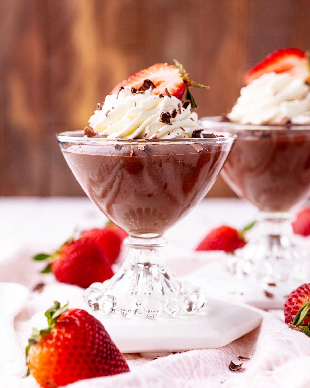 A dessert cup full of chocolate pudding.
