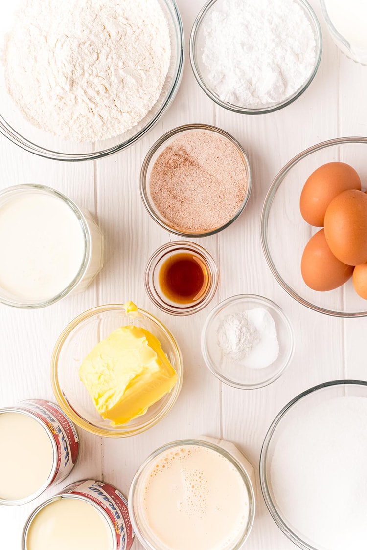 The ingredients to make tres leches cake, all separated into bowls.