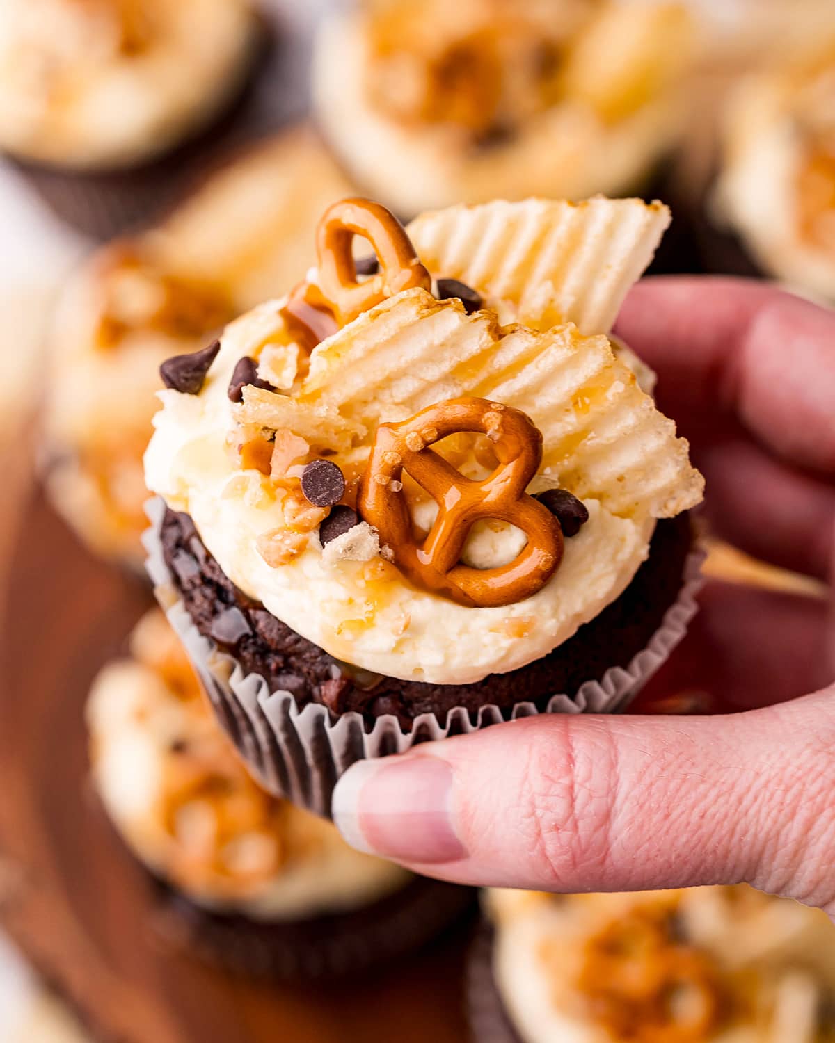 A hand holding a kitchen sink cupcake.