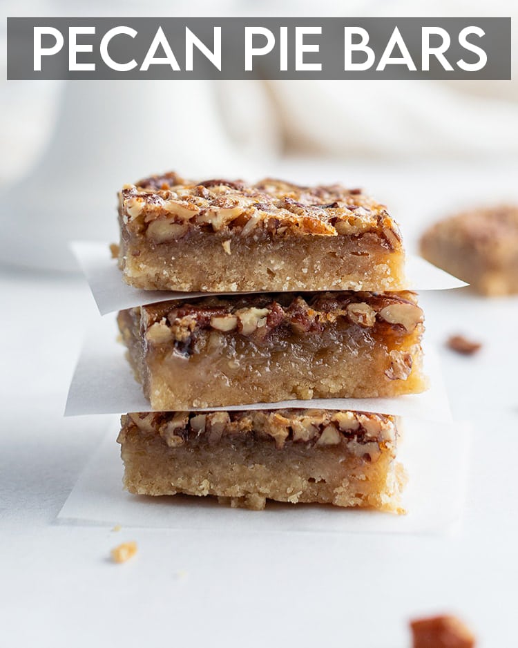 A stack of pecan pie bars with parchment paper between each one with a text overlay saying Pecan Pie Bars
