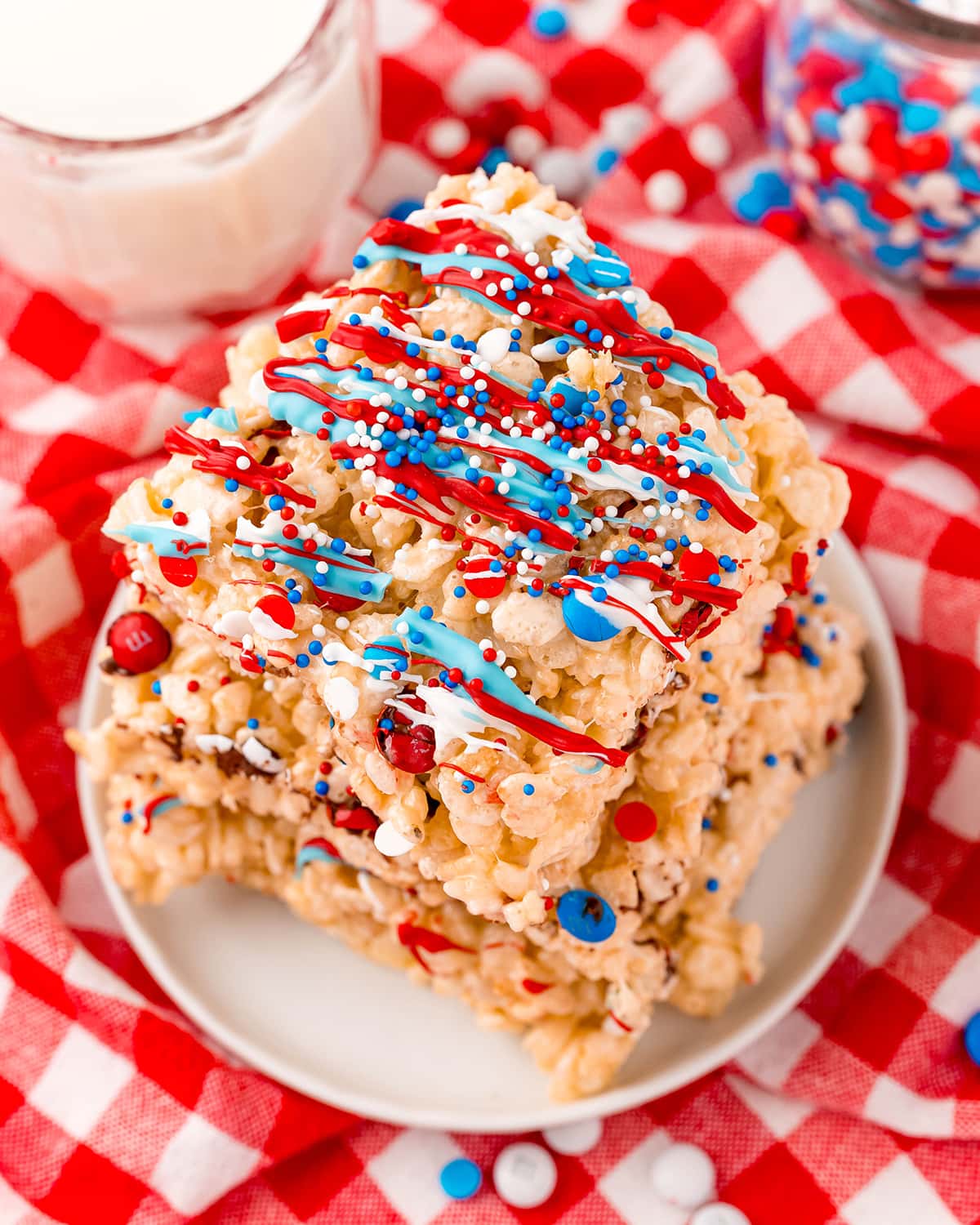 A plate of Red, White, and Blue topped rice krispie treats.
