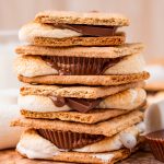 A stack of s'mores made in the air fryer, with a mix of Hershey's Chocolate bars and Reeses Cups inside the graham crackers.