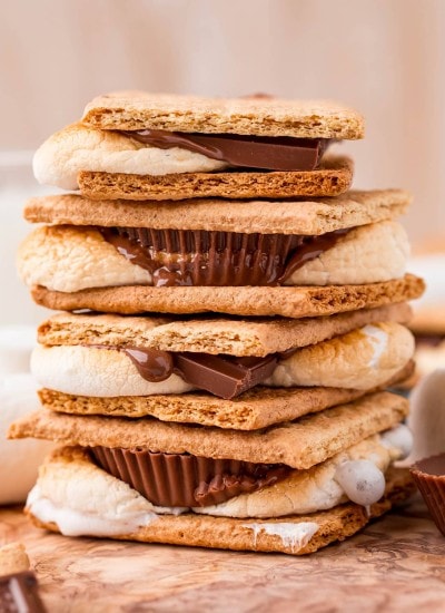 A stack of s'mores made in the air fryer, with a mix of Hershey's Chocolate bars and Reeses Cups inside the graham crackers.