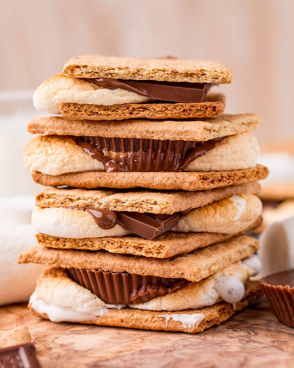 A stack of s'mores made in the air fryer, with a mix of Hershey's Chocolate bars and Reeses Cups inside the graham crackers.