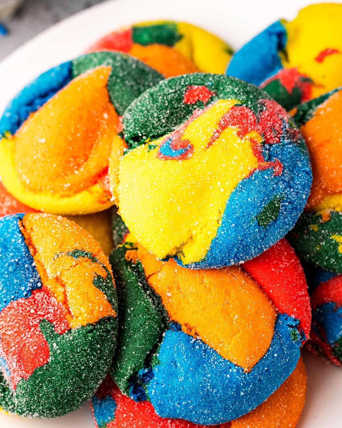 A pile of rainbow swirled cookies.