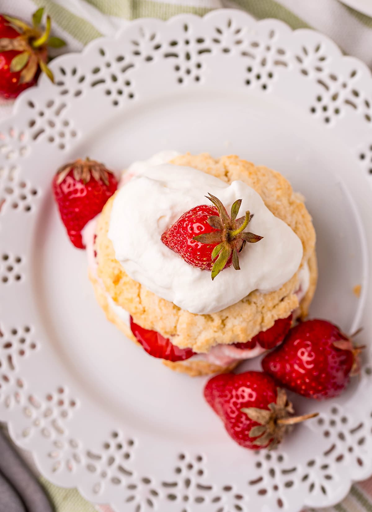 An overhead shot of a strawberry shortcake on a plate.