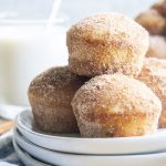 A pile of cinnamon sugar donut muffins on a white plate.