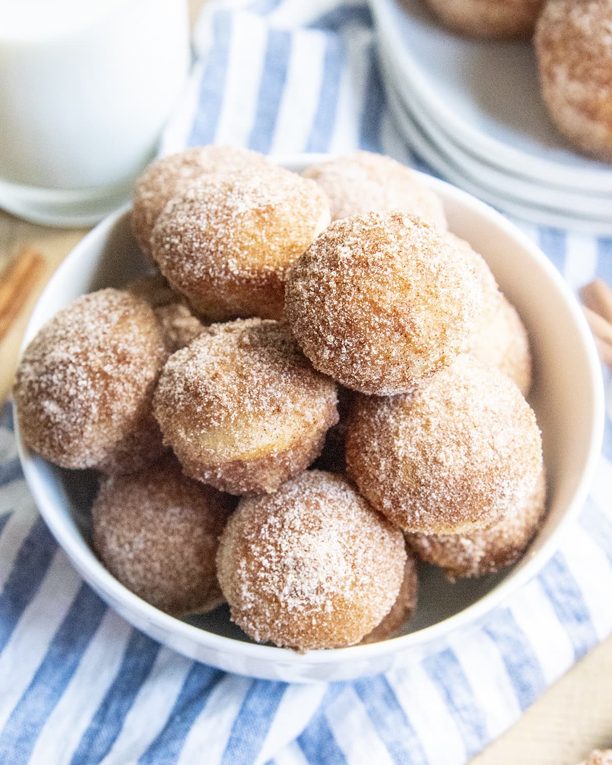 A bowl full of cinnamon sugar donut muffins.