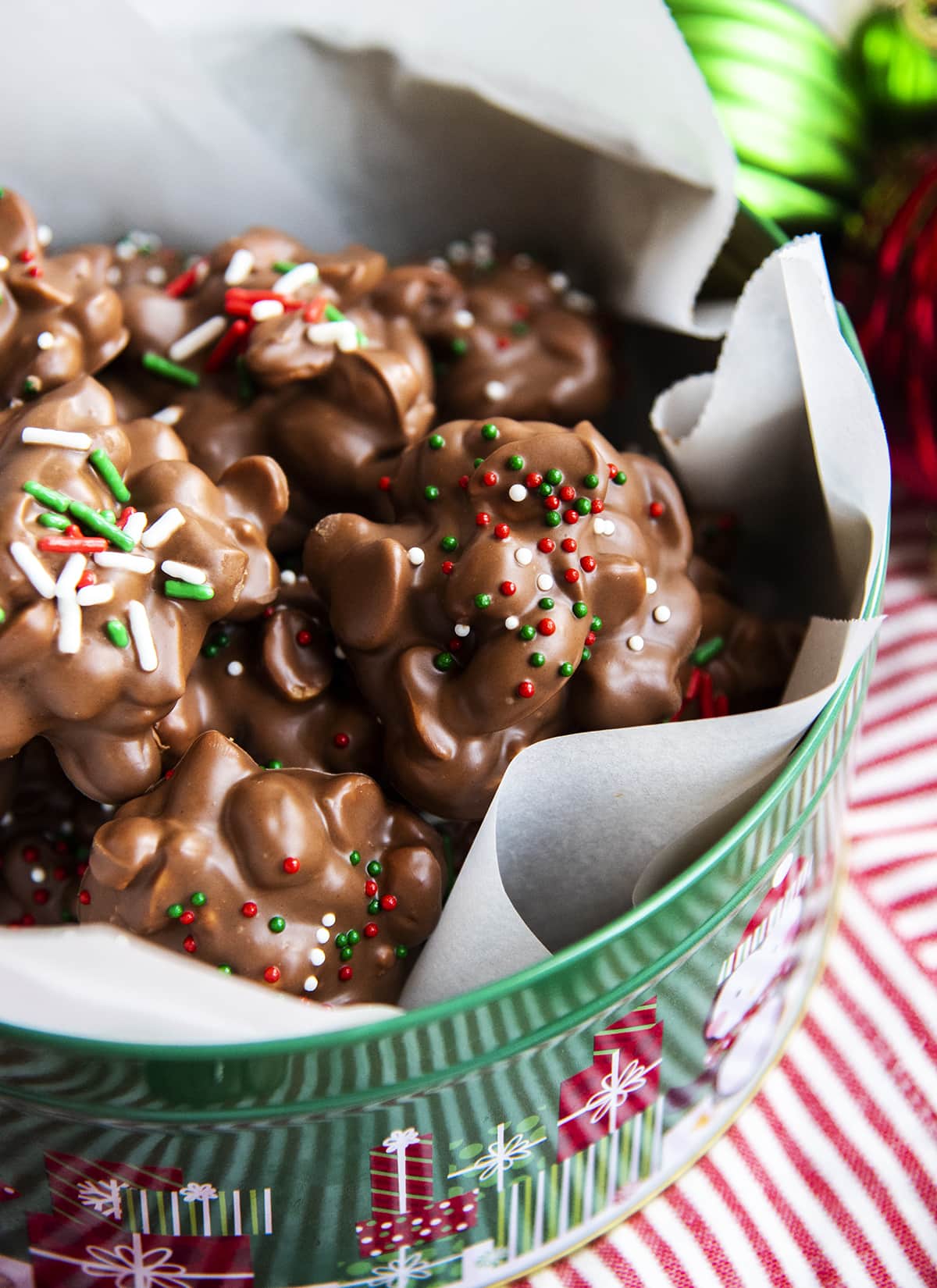 Crockpot candy peanut clusters piled in a tin.