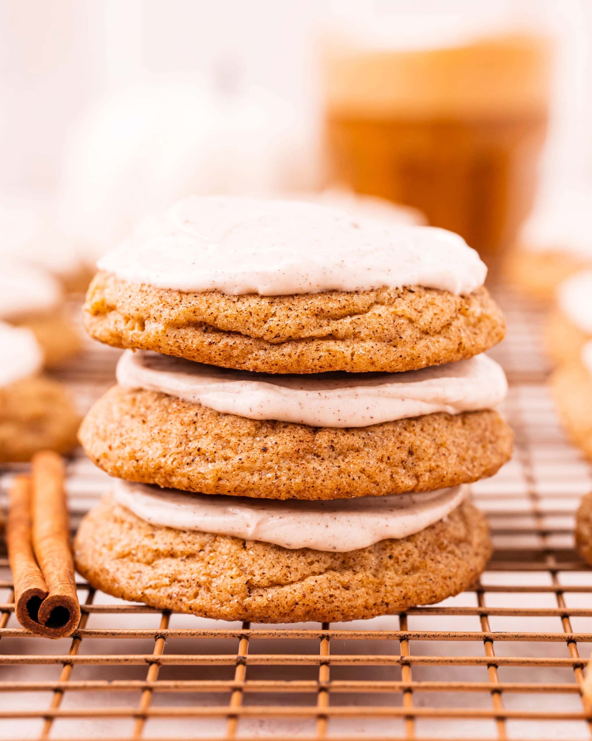A stack of three cream cheese frosted pumpkin cookies.