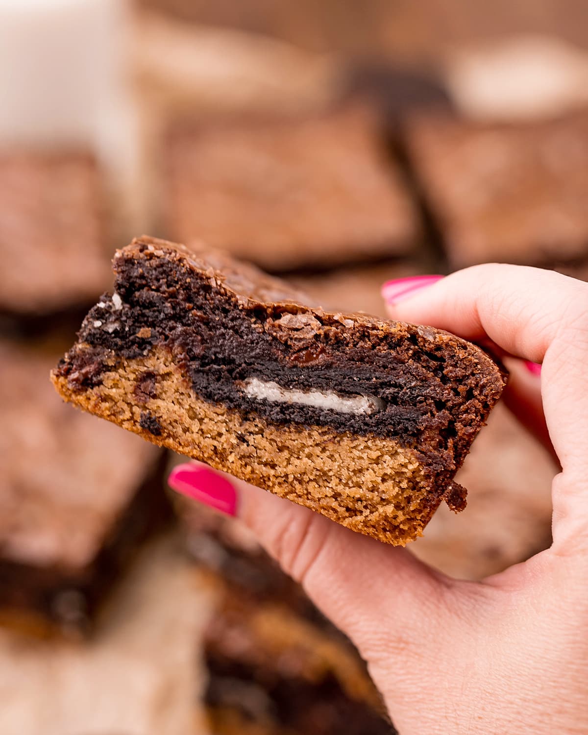 A hand holding a brookie bar.