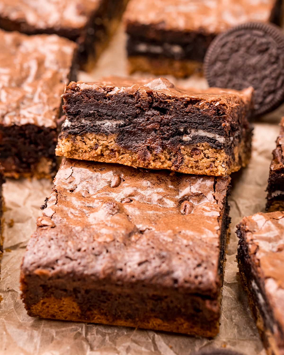 A cookie bar with chocolate chip cookie, an Oreo, and brownie on top.
