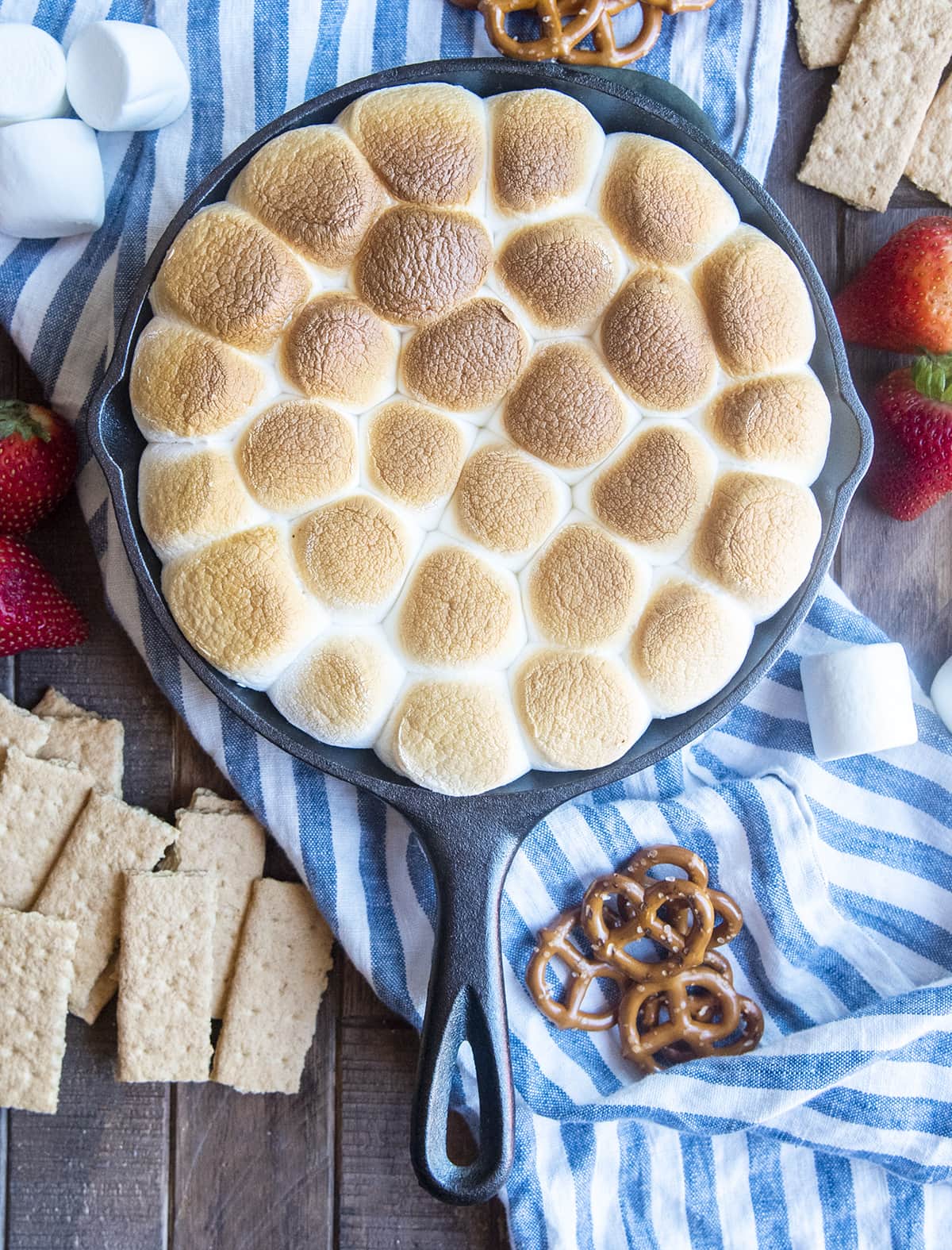 A cast iron pan full of toasted marshmallows.