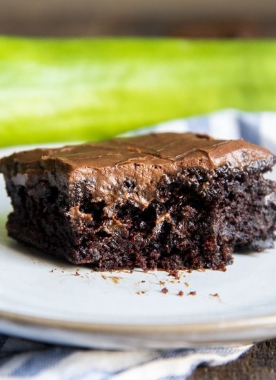 A close up of a chocolate zucchini brownie, with icing.