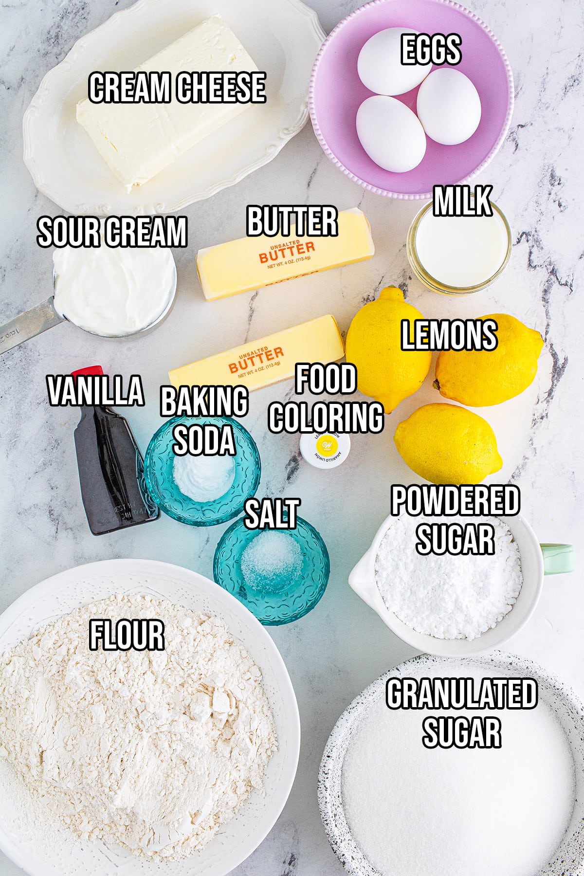 An overhead photo of the ingredients needed to make lemon cream cheese bundt cake with text overlaying each ingredient.
