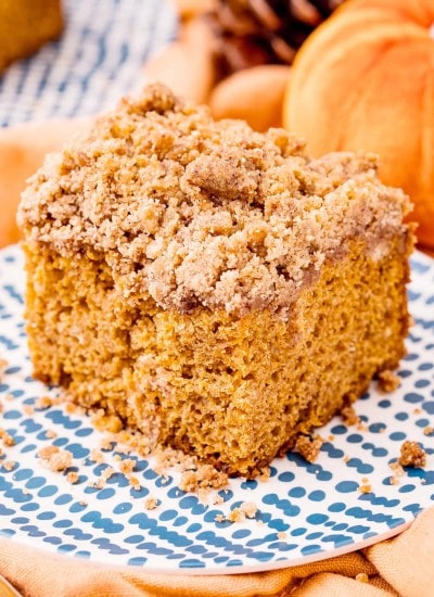 A piece of pumpkin coffee cake with a brown sugar streusel crumb topping on top.