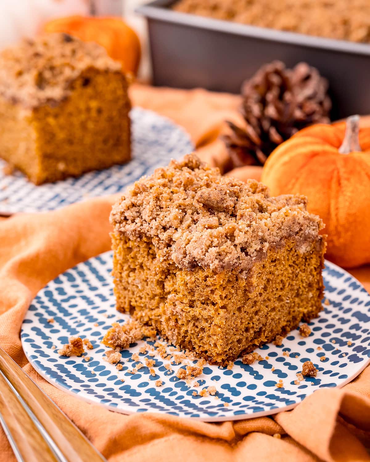 A piece of pumpkin coffee cake with a sugar crumble topping.