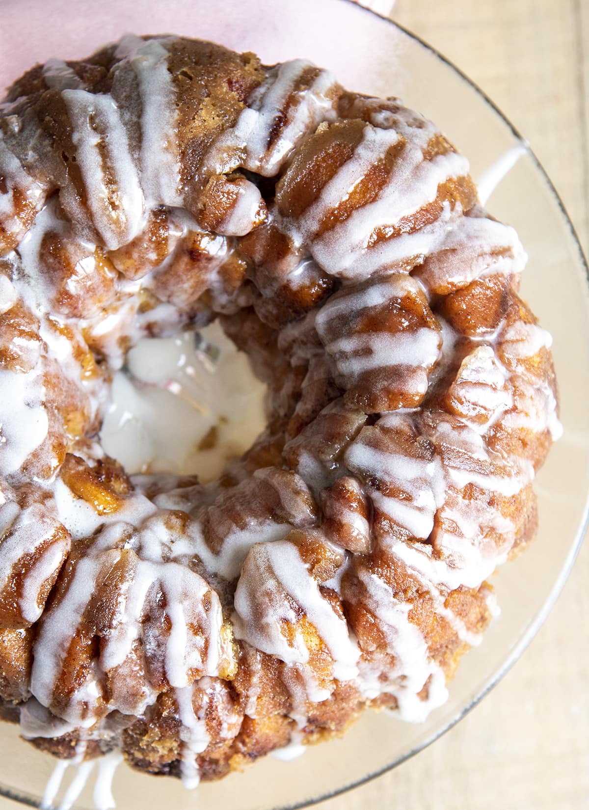 An overhead shot of cinnamon roll monkey bread, showing the white icing drizzled over the top.