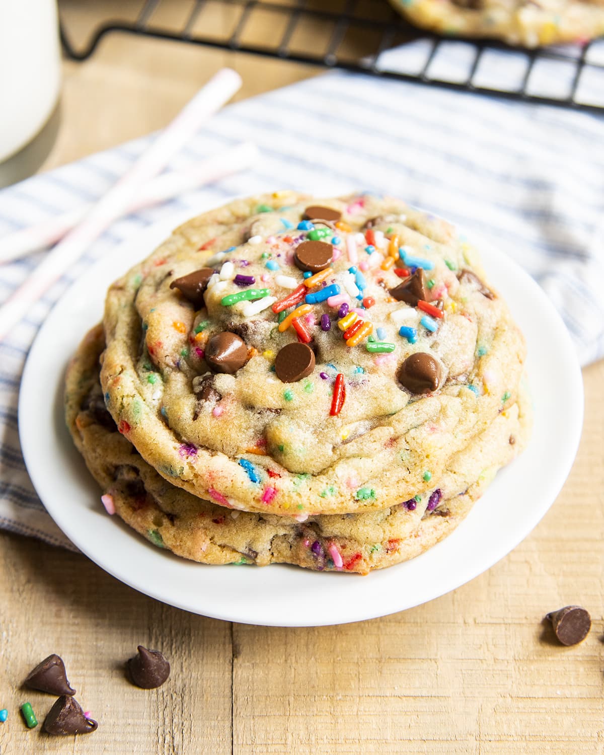 A small plate full of two big funfetti chocolate chip cookies.
